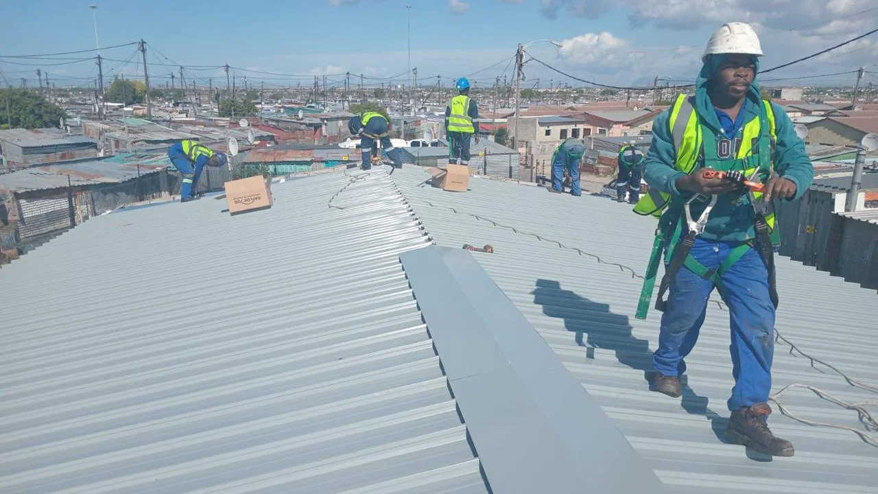 Team members working on a roofing installation
